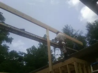 Carpenter setting a ridge beam over a new addition frame — Ice Dam Removal by Roofing Brothers in Sun Valley